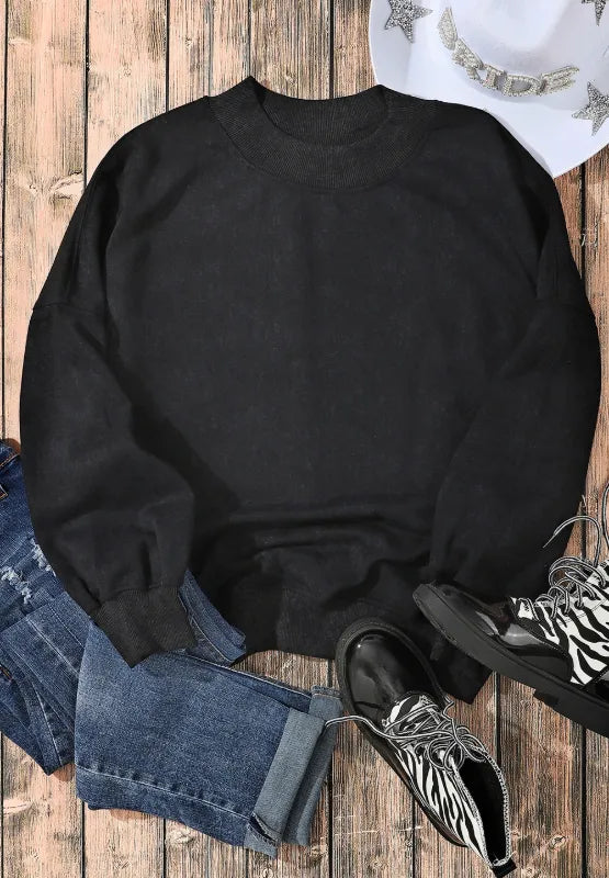 Black mock neck dropped-shoulder sweatshirt laid flat
