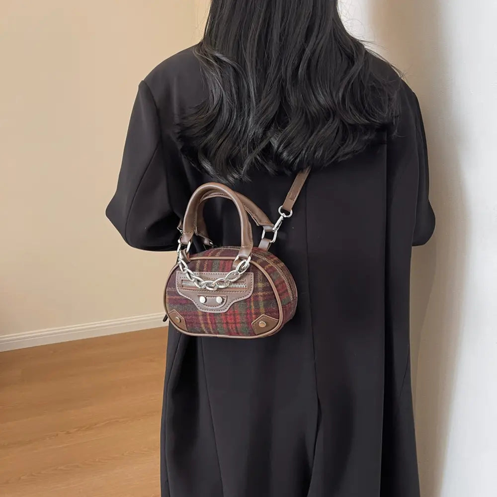 Brown plaid crossbody bag with top handles, chain strap, and silver ring hardware