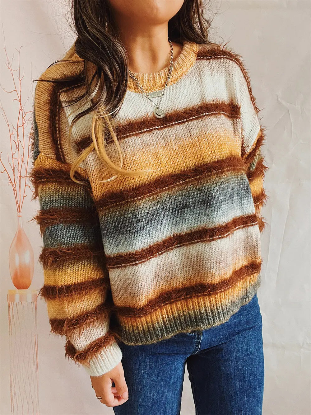 Striped round-neck long-sleeve sweater with rust-brown, tan, white, and dark gray stripes