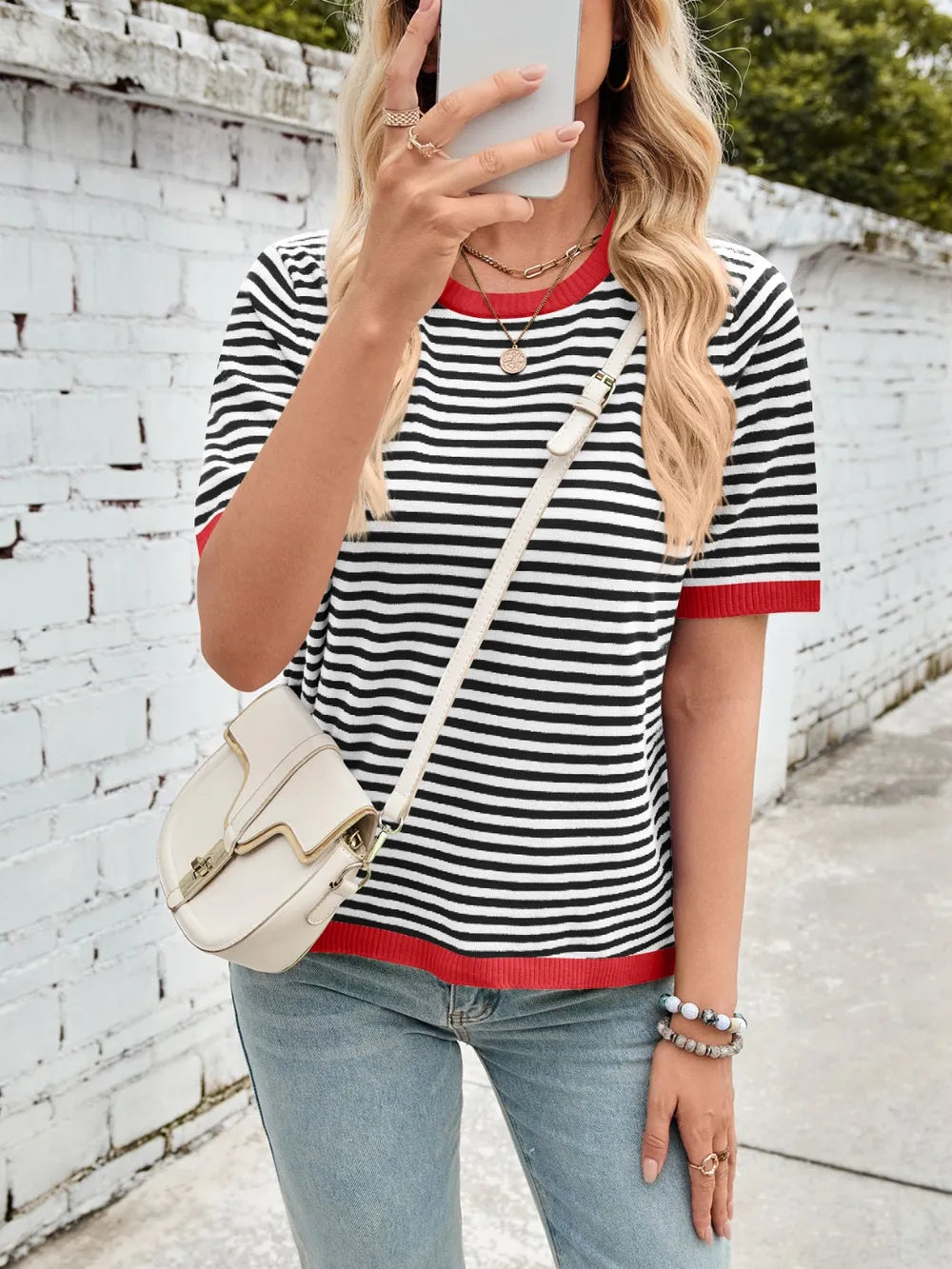 Striped knit top, black-and-white stripes with red ribbed crew neck and sleeve cuffs