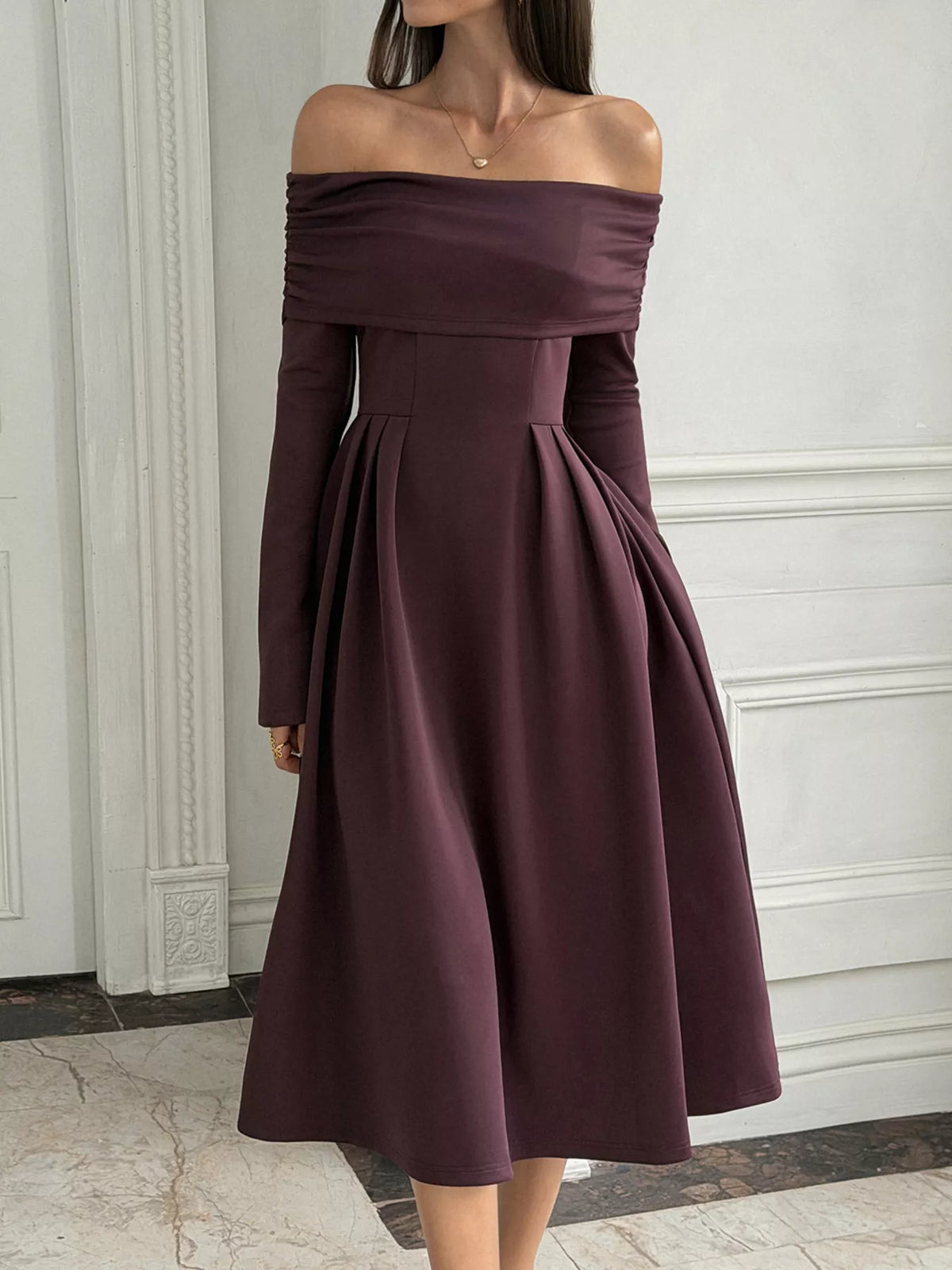 Burgundy off-shoulder midi dress with ruched neckline, long sleeves, and pleated skirt