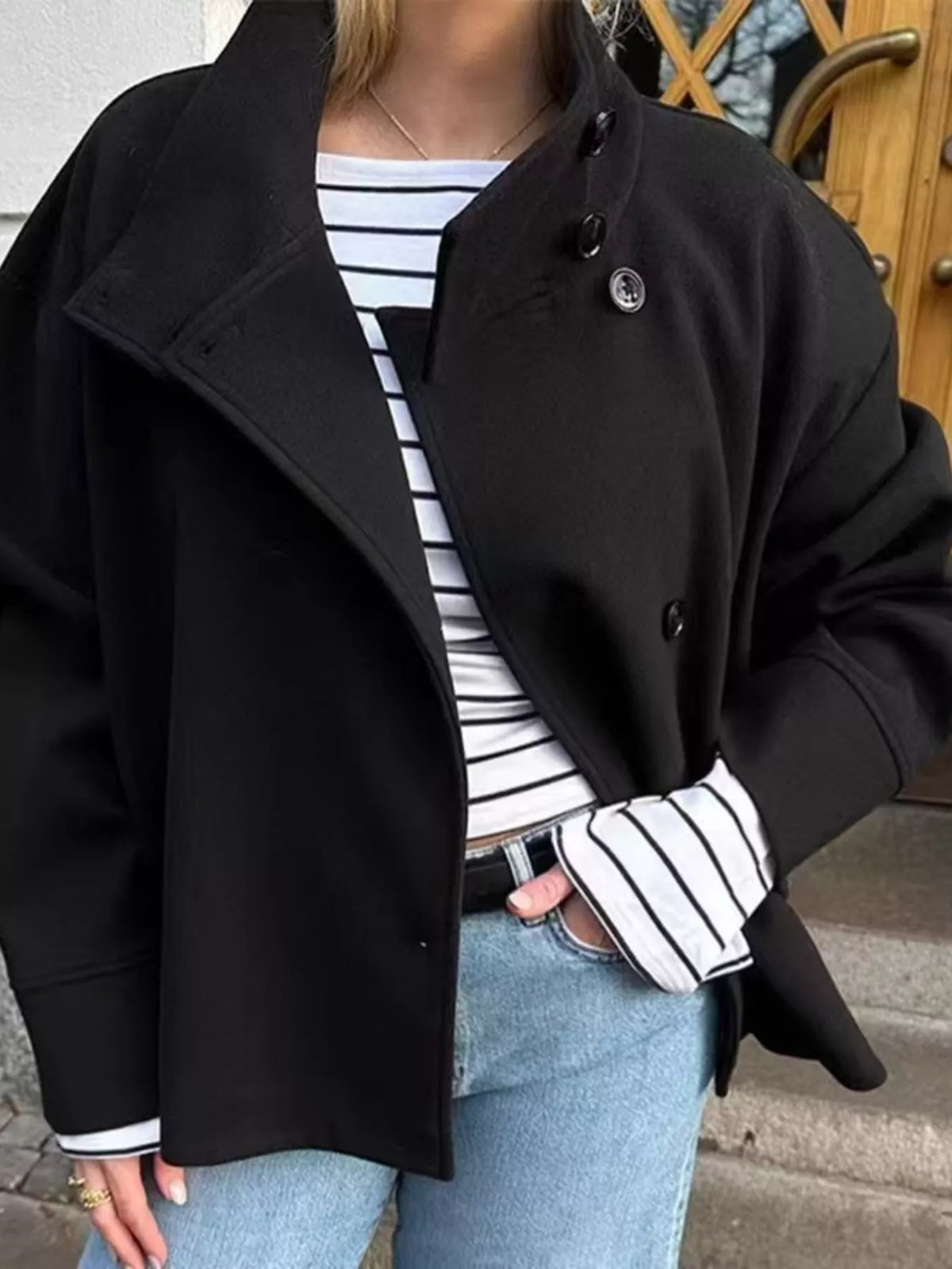 Black long-sleeve button-front jacket with stand collar and double-breasted look