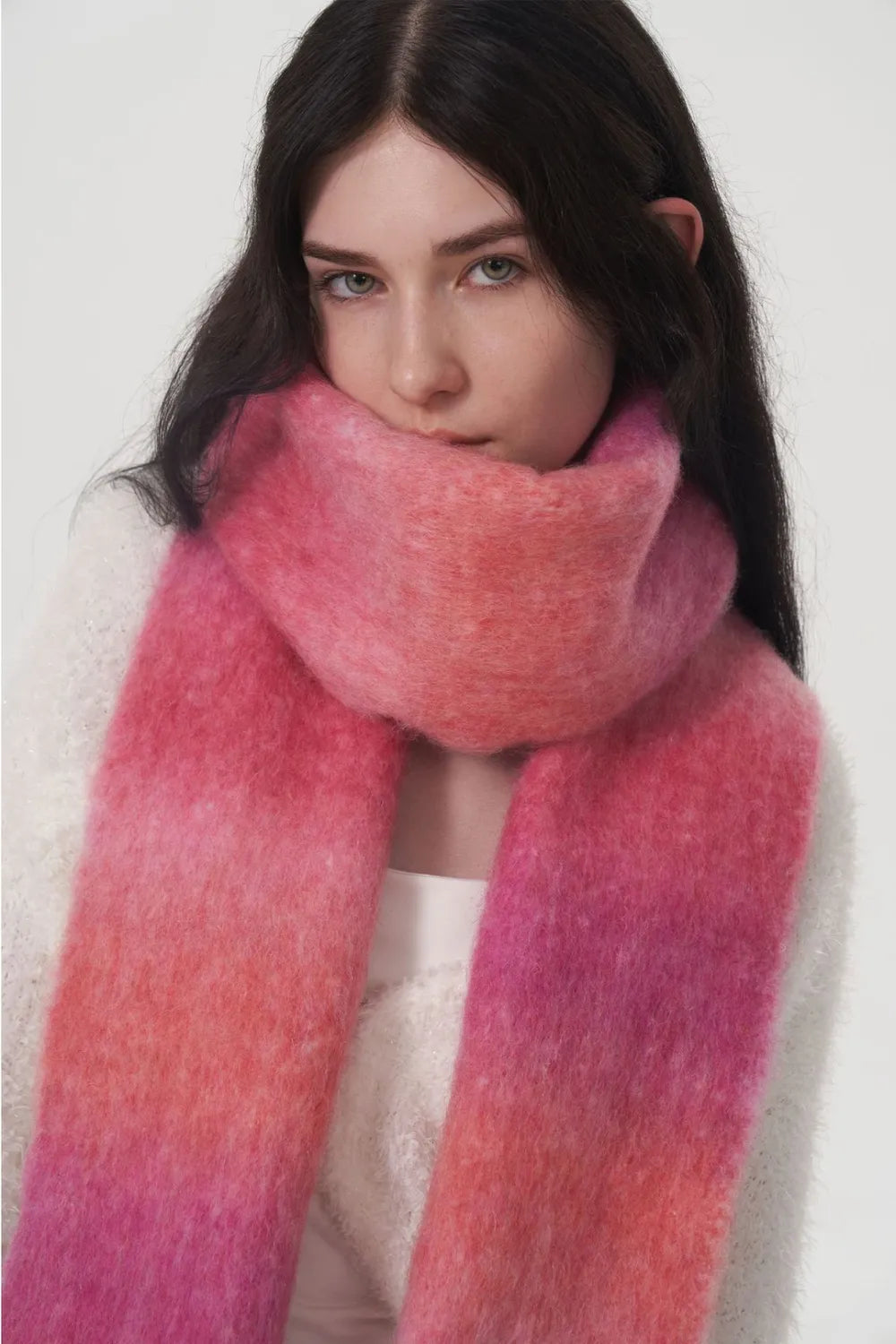 Pink gradient thermal scarf with fuzzy weave and fringed edges.