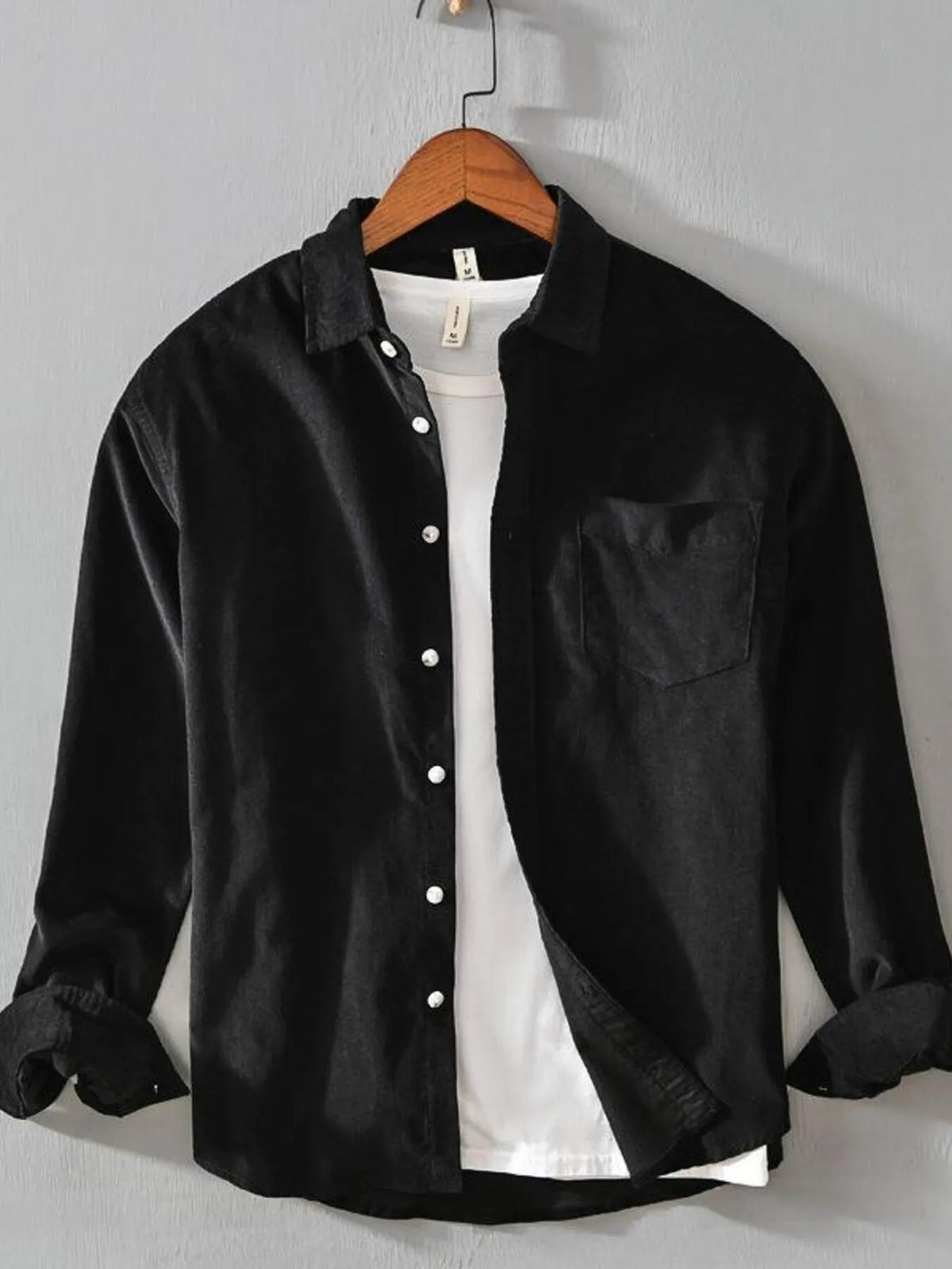 Men's black cotton button-up shirt with long sleeves, button front, and chest pocket