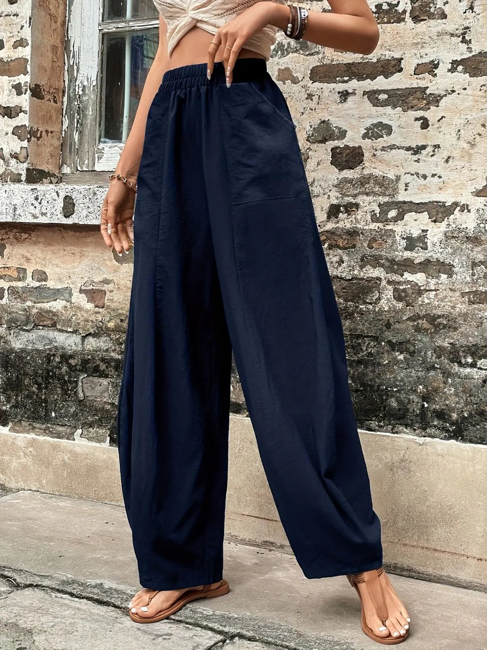 Dark blue elastic-waist pants with roomy wide legs and side pockets