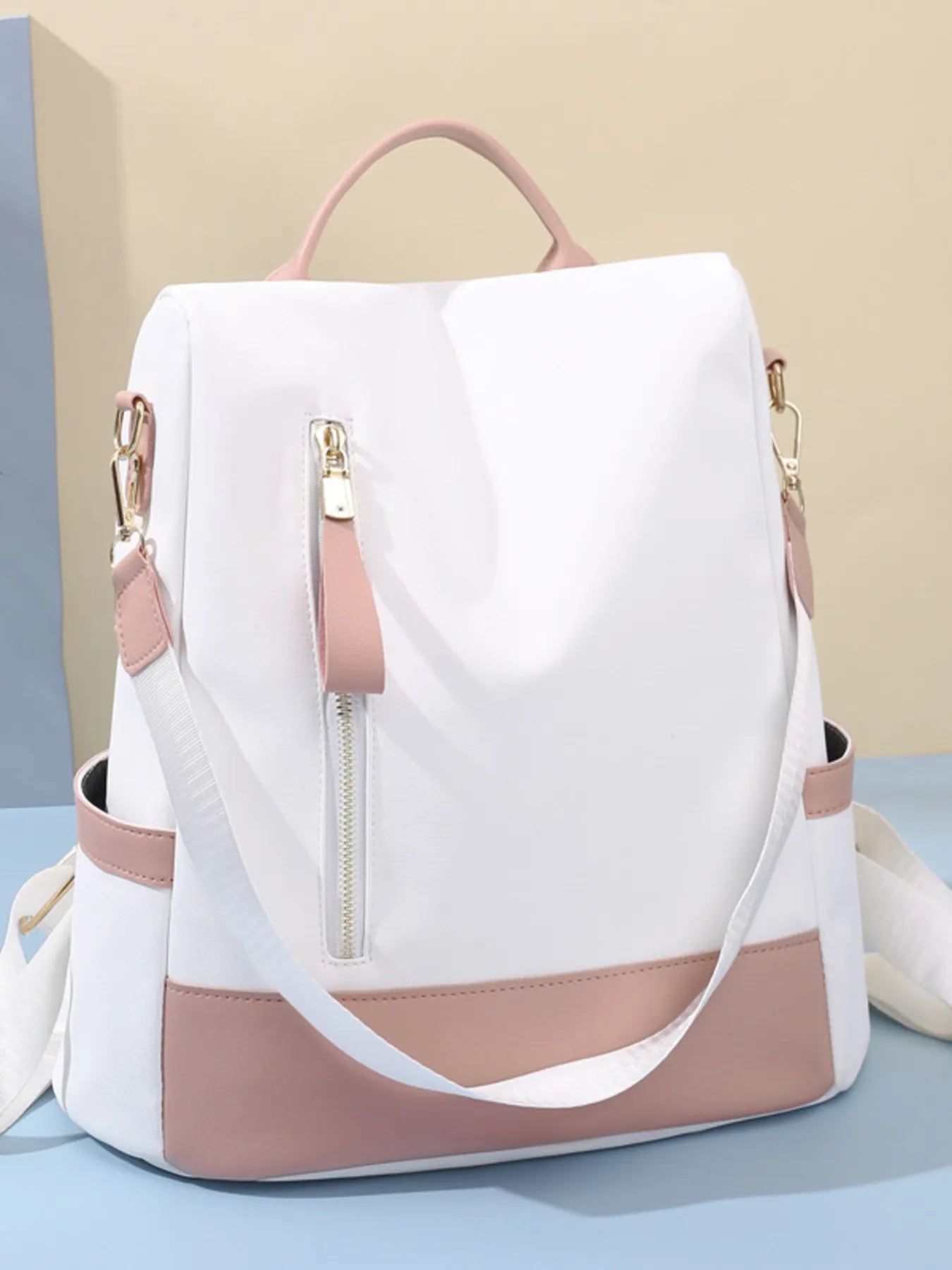 White and dusty pink convertible backpack bag with front zip pouch, top handle, and straps