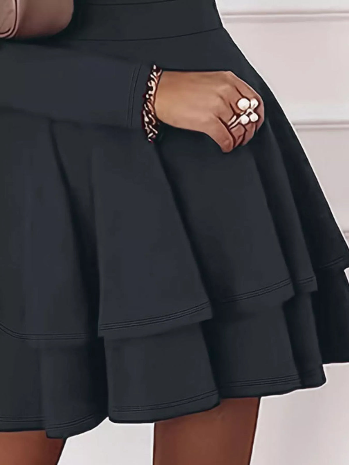 Black tiered ruffle mini dress skirt with layered flares and stitched seam lines