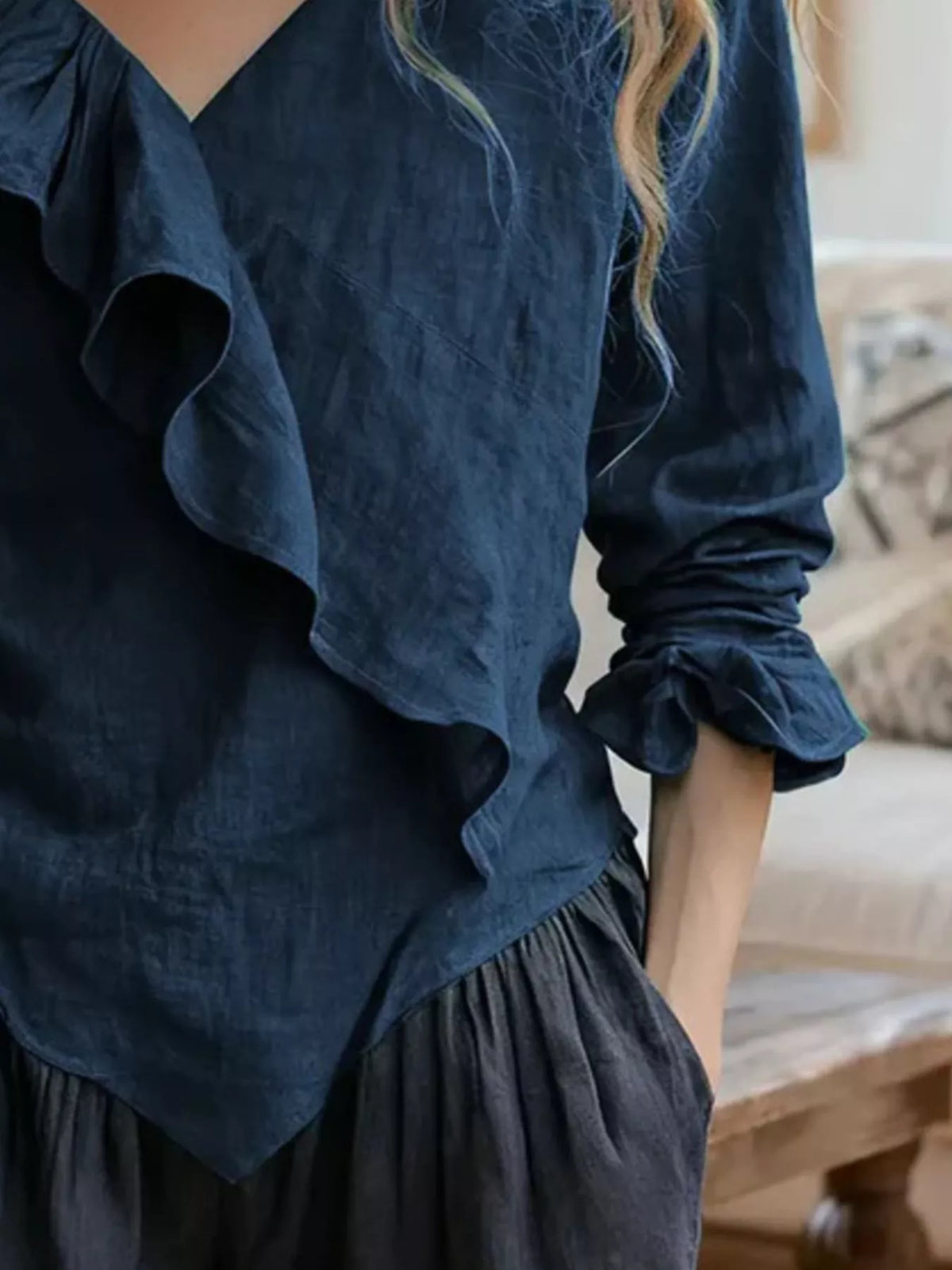 Navy ruffled V-neck blouse with long sleeves and tiered peplum hem