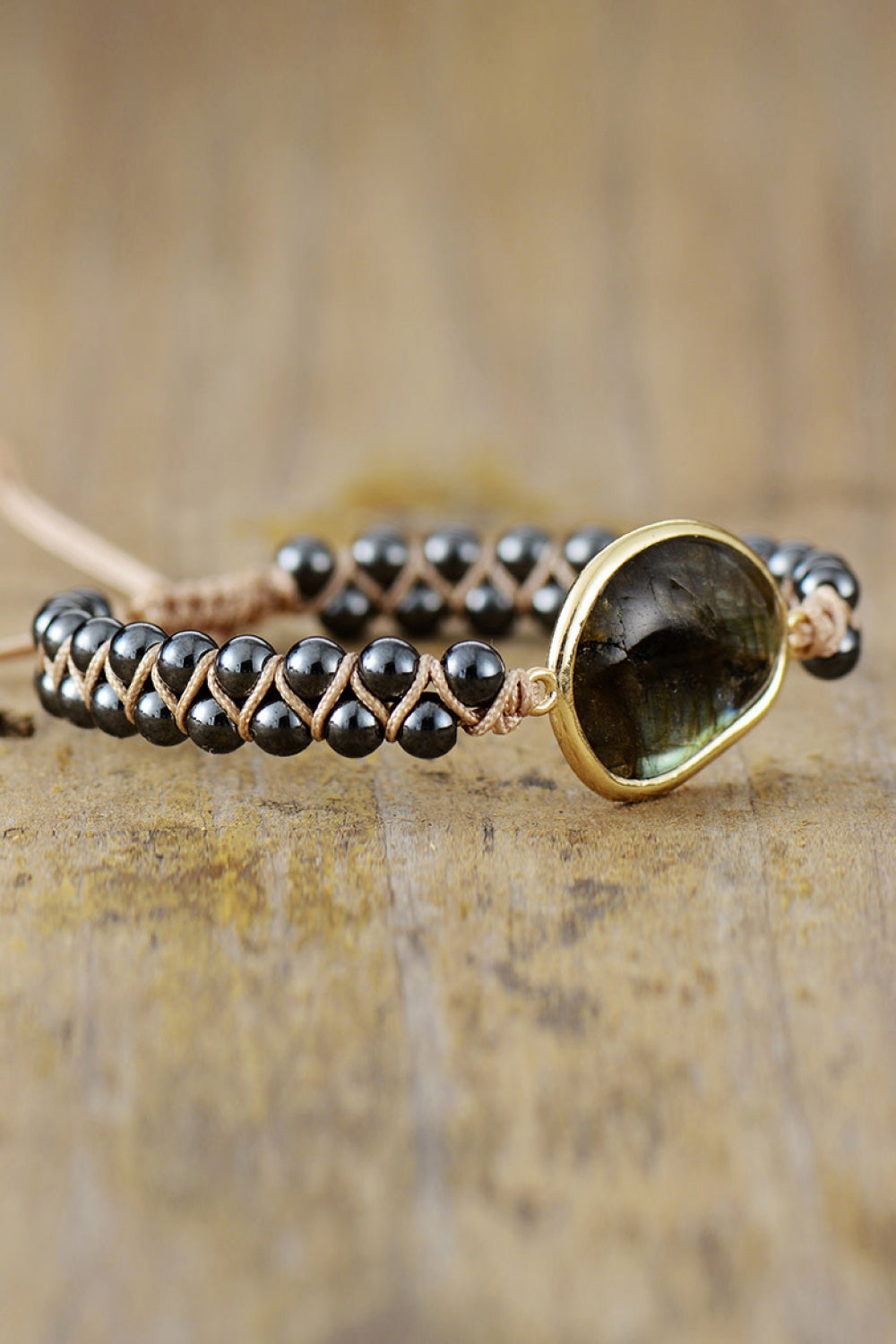 Black bead bracelet with gold-tone oval labradorite centerpiece on stone clasp