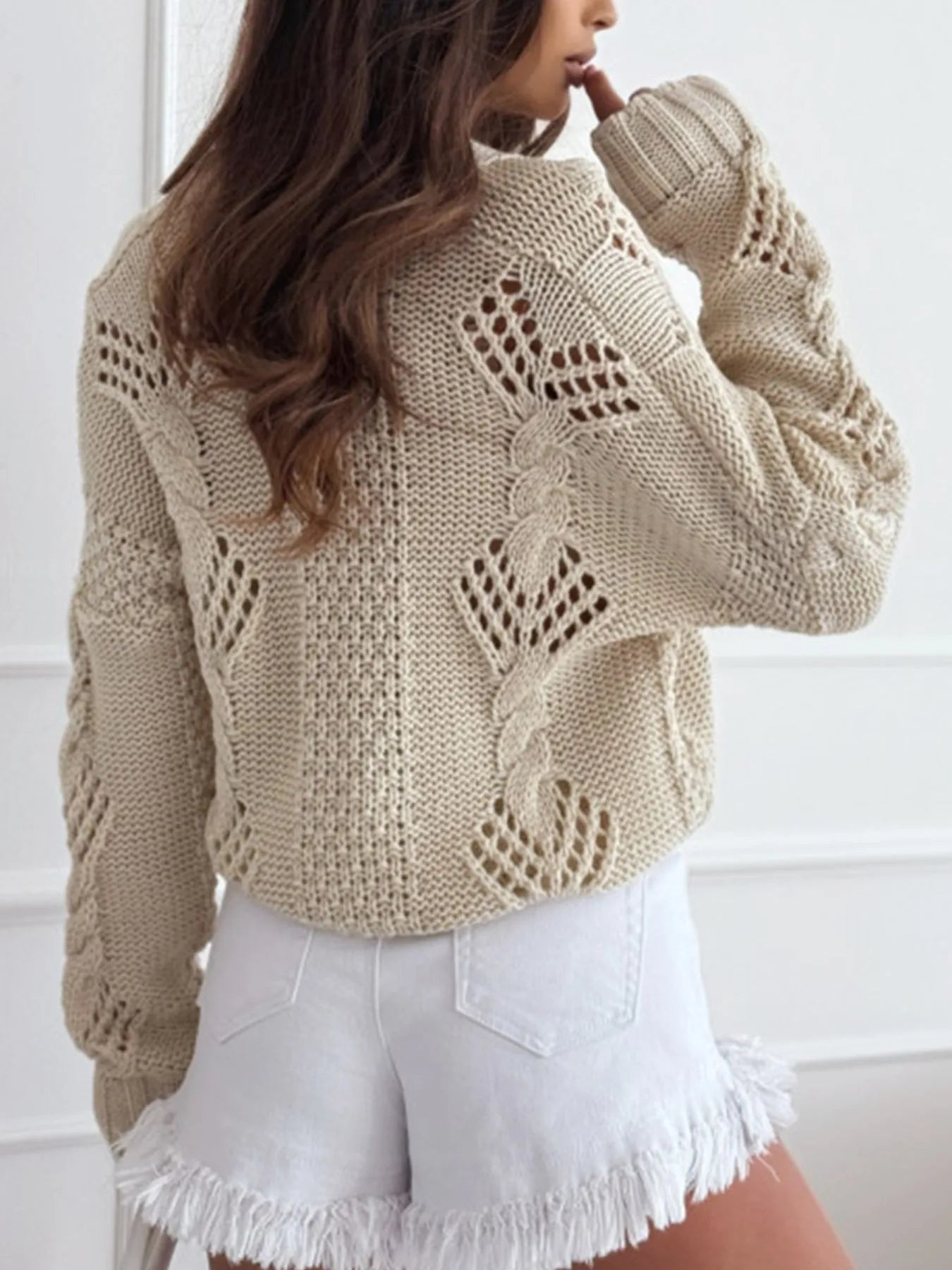 Beige chunky cropped cardigan with textured cable-knit pattern and long sleeves