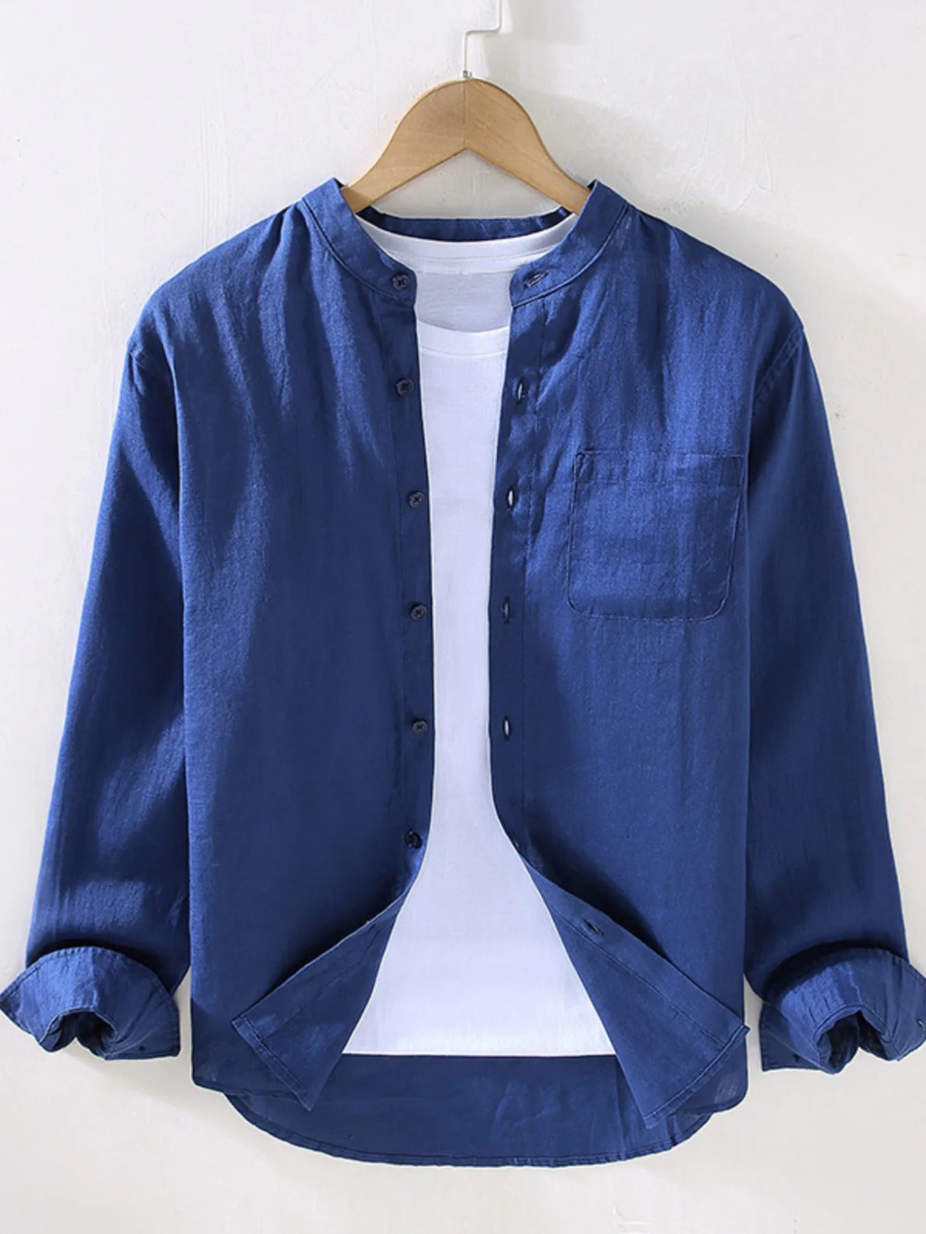 Men's long sleeve button-up shirt in blue with front buttons and chest pocket