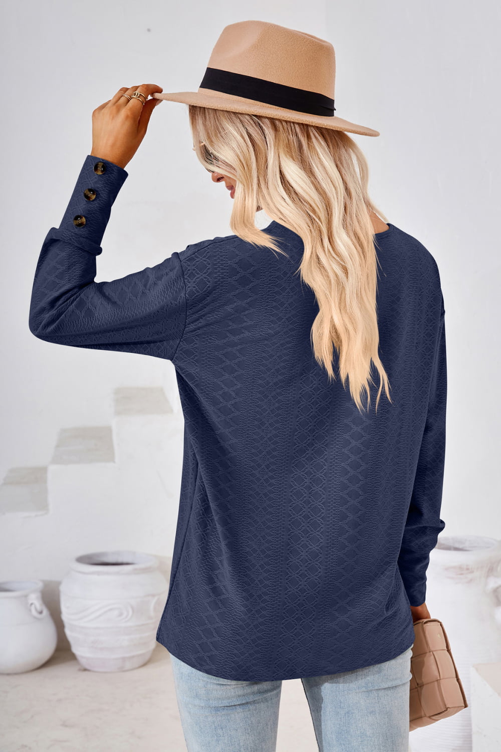 Dark blue V-neck long-sleeve blouse, back view, textured diamond pattern