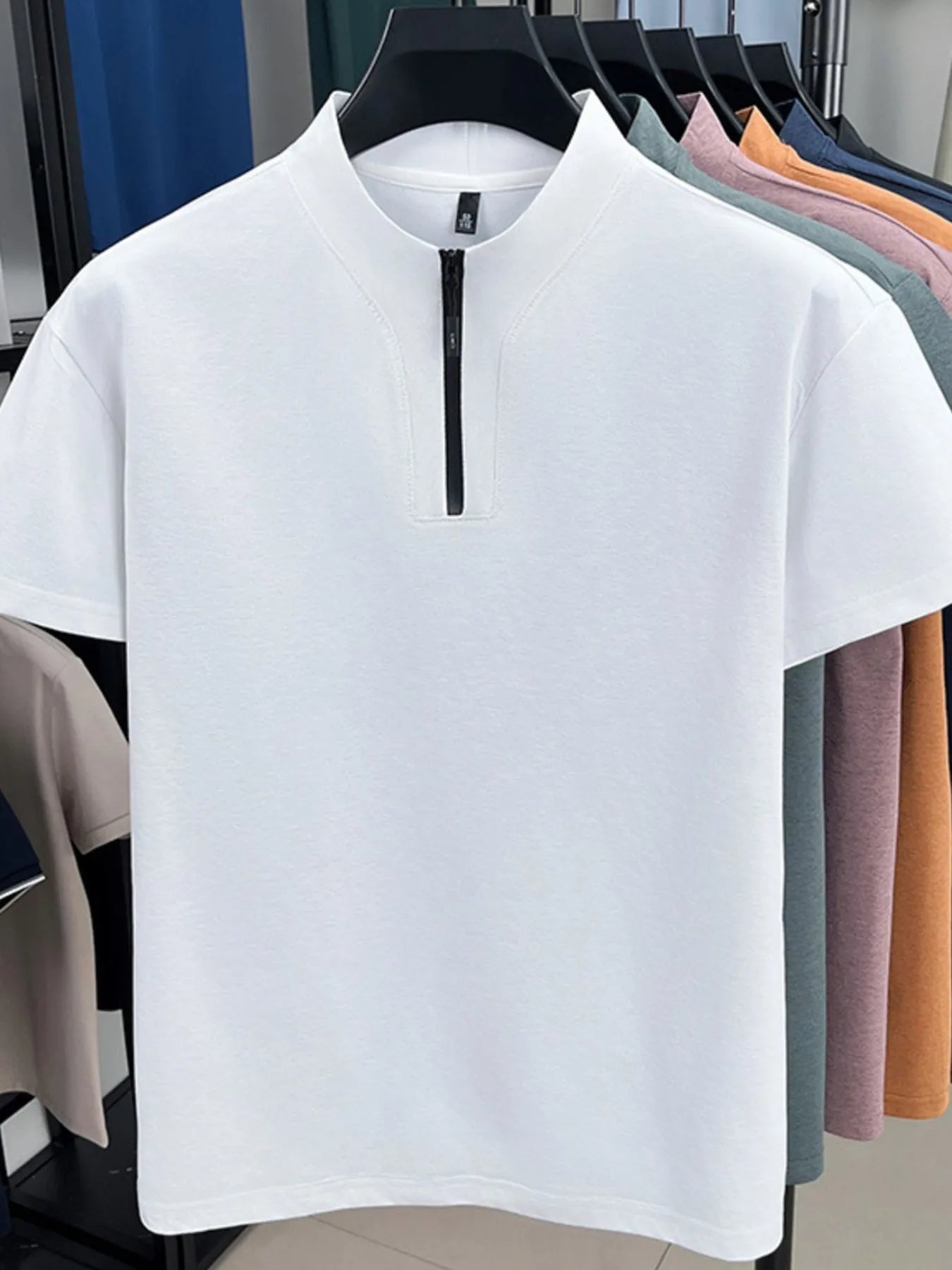 White quarter-zip short-sleeve top with stand collar and front zipper