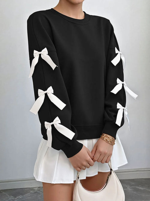 Black round-neck sweatshirt with white bow ties on balloon sleeves