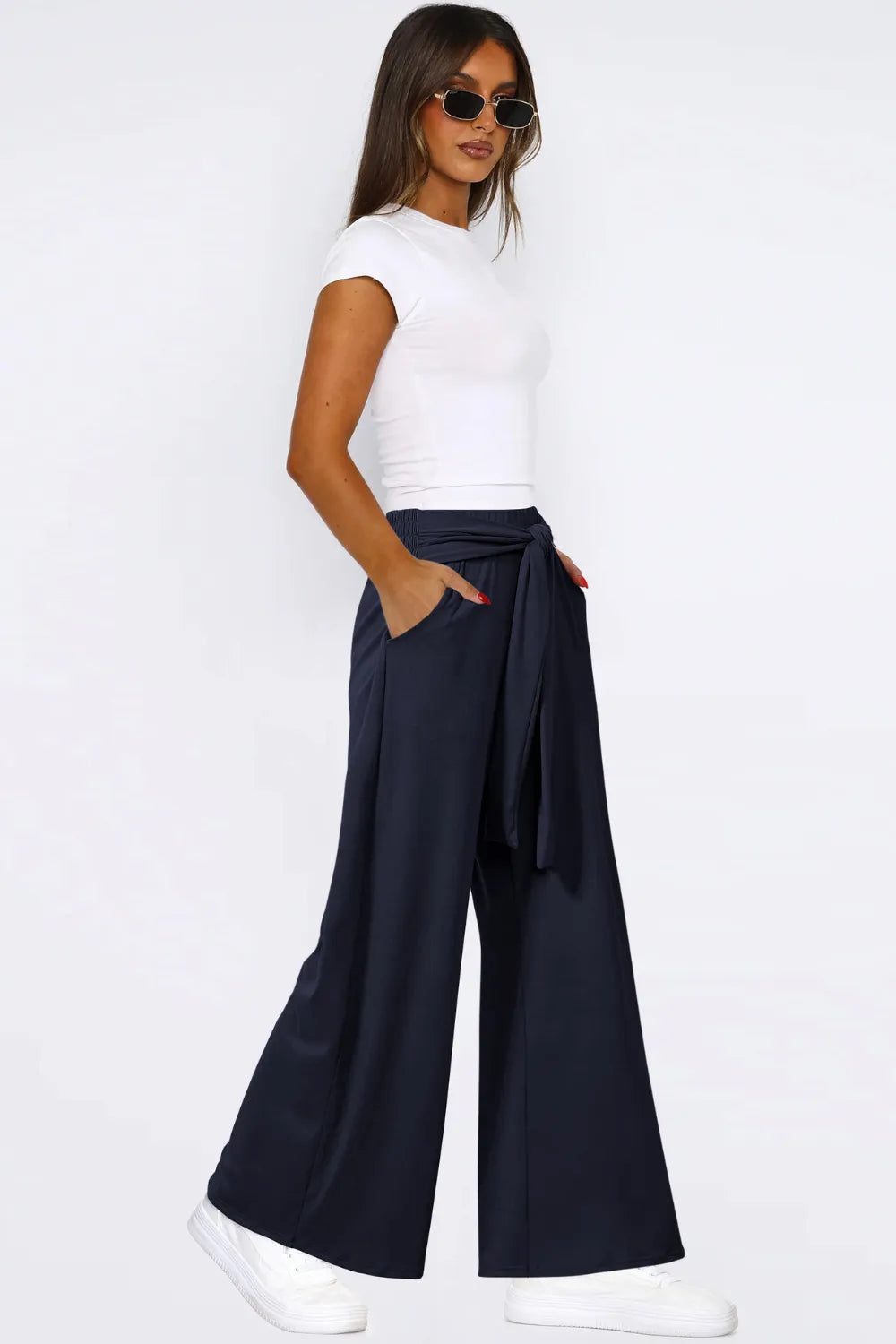Dark navy wide-leg pants with tied waist and side pockets, loose straight legs.