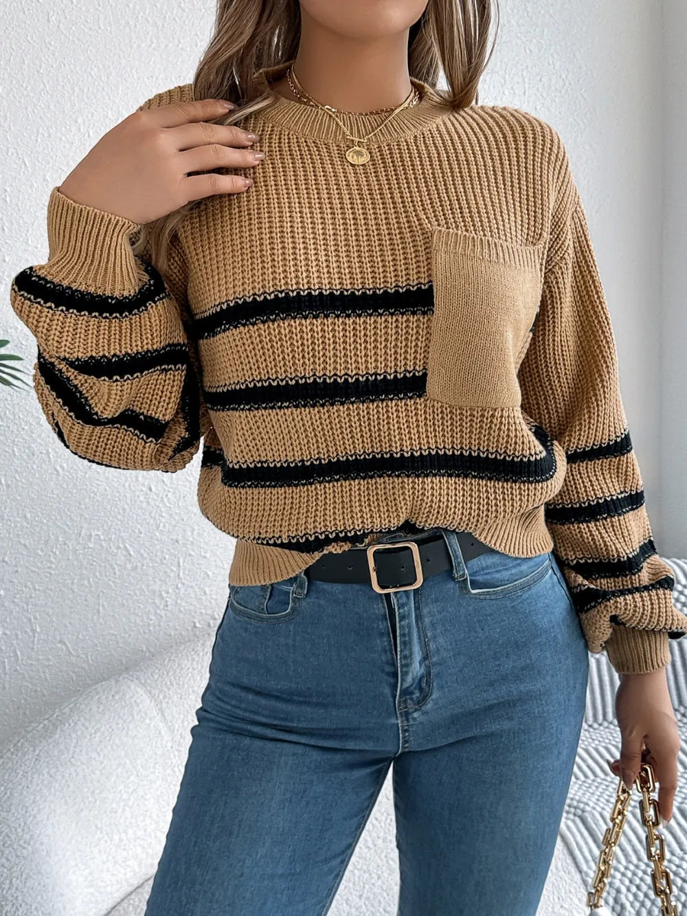 Caramel striped knit sweater with round neck and long sleeves, chest pocket and ribbed cuffs