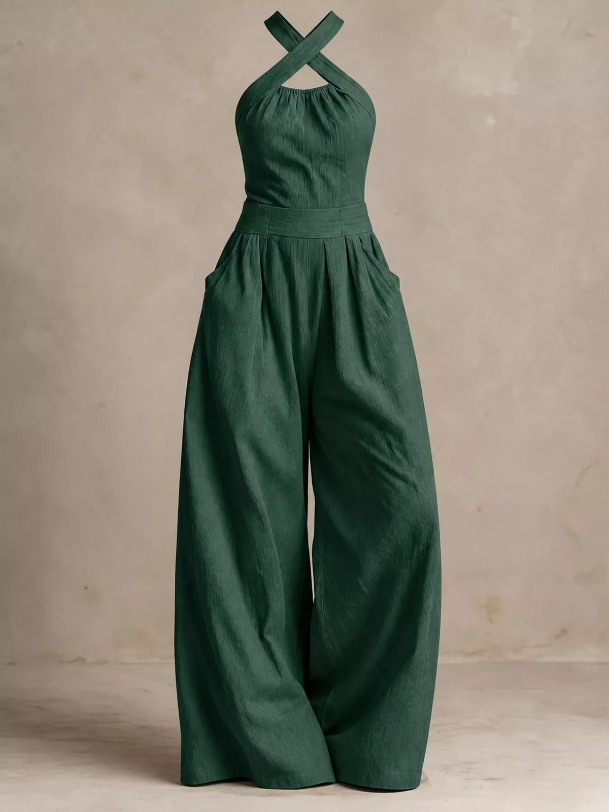 Dark green linen halter jumpsuit with tie neck and high-waist wide legs