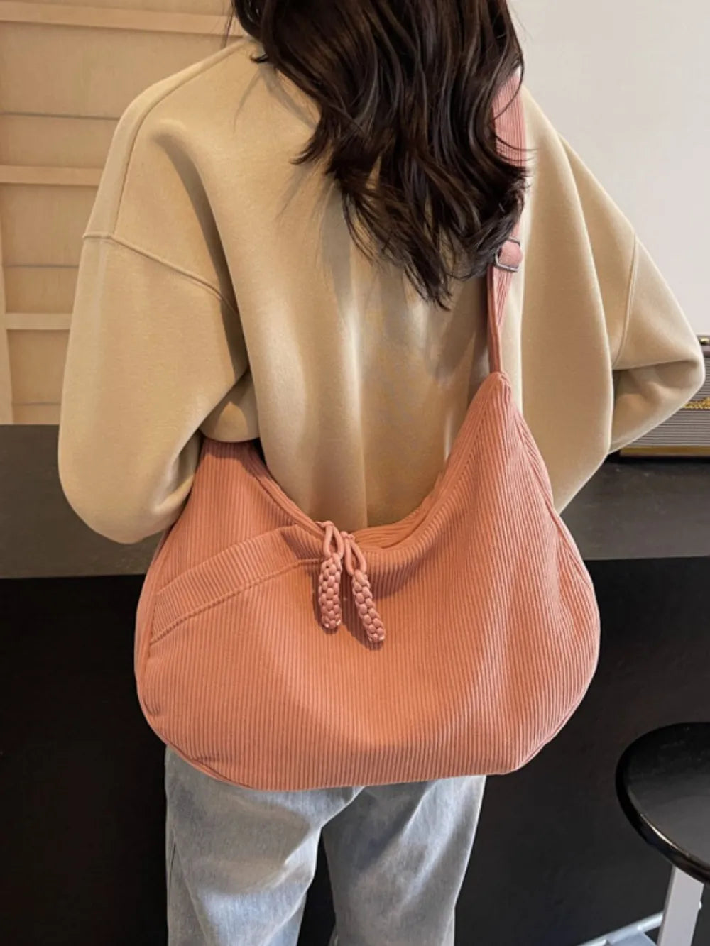 Ribbed pink adjustable strap shoulder bag with drawstring pouch top