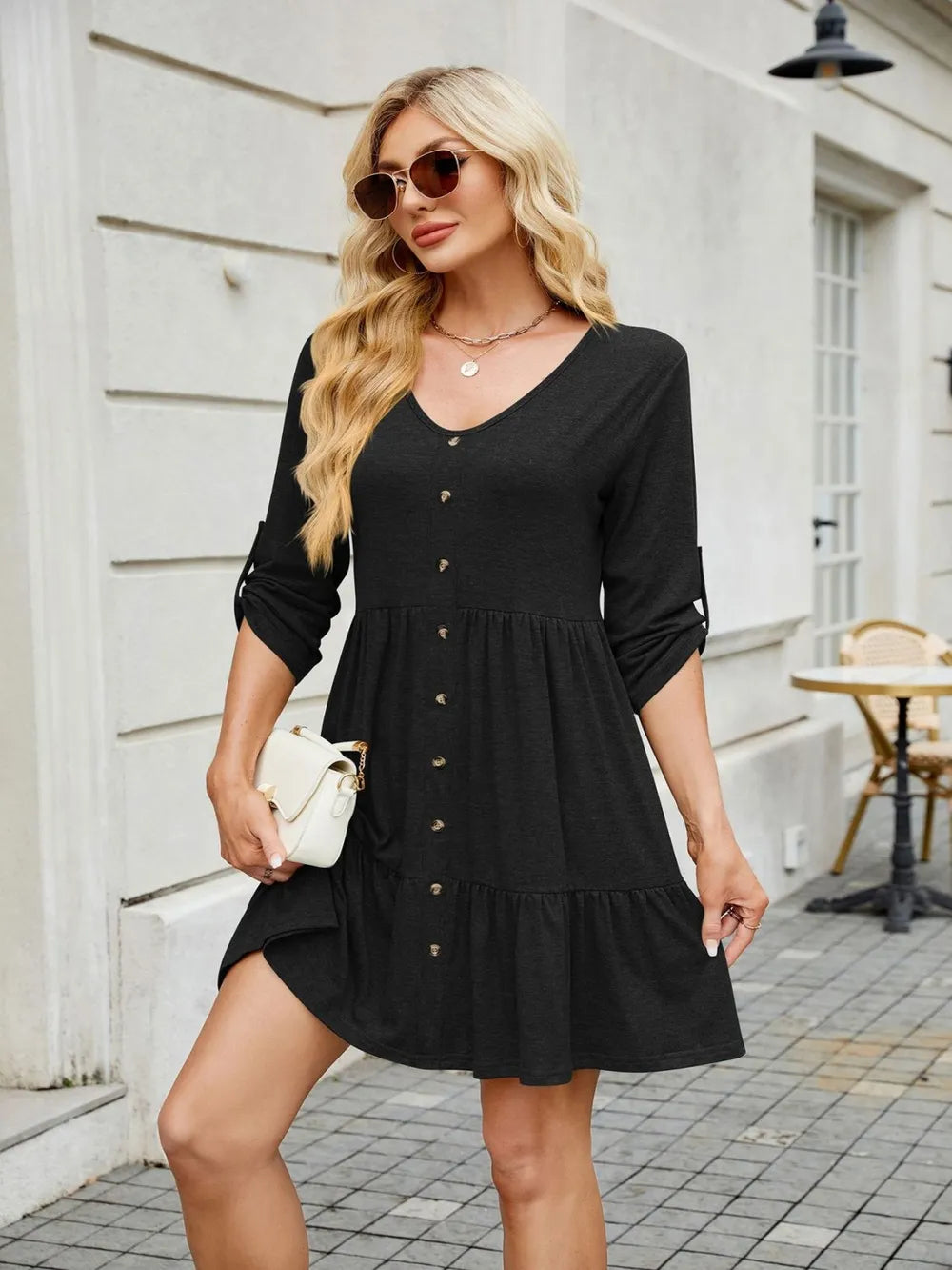 Tiered ruched v-neck mini dress in black with button-front detailing