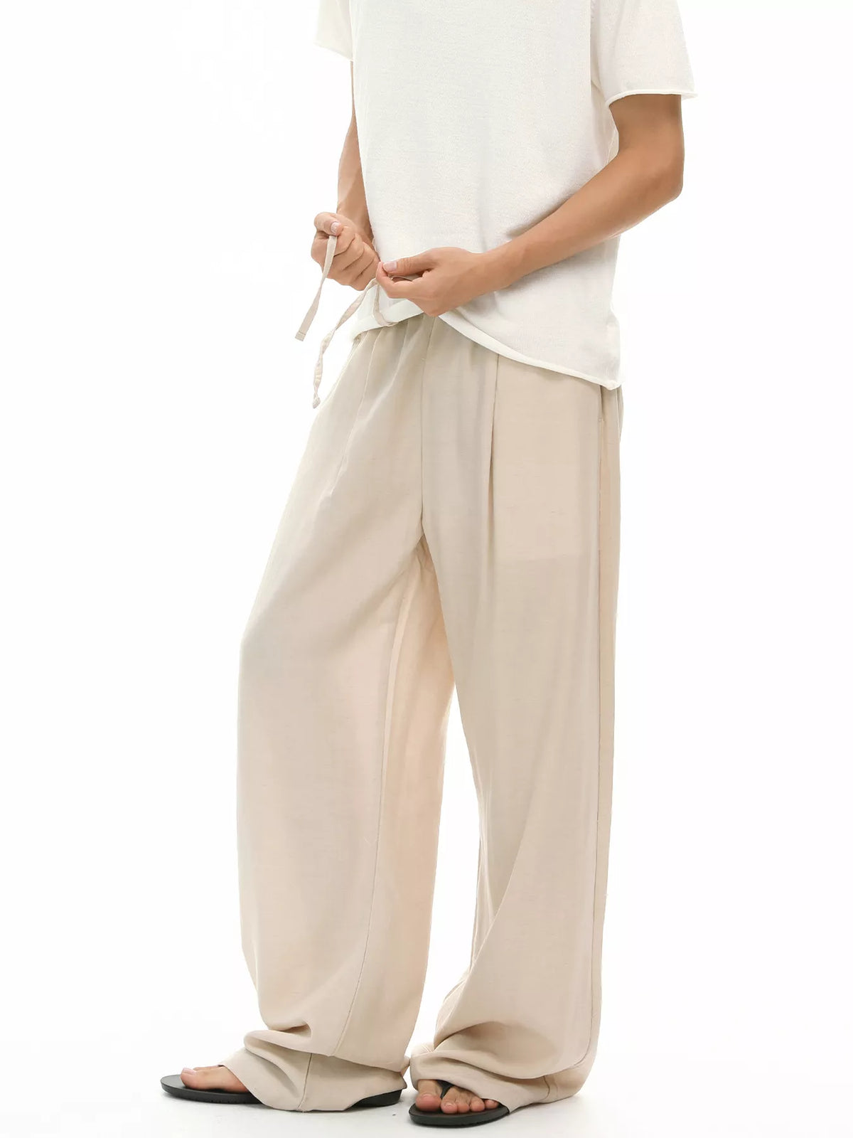 Khaki wide-leg drawstring pants with gathered waist and roomy straight legs
