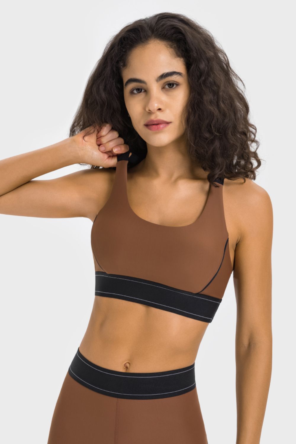Brown sports bra with black contrast band and scoop neckline