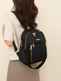 Black quilted oxford backpack with front and side zip pockets, adjustable shoulder strap