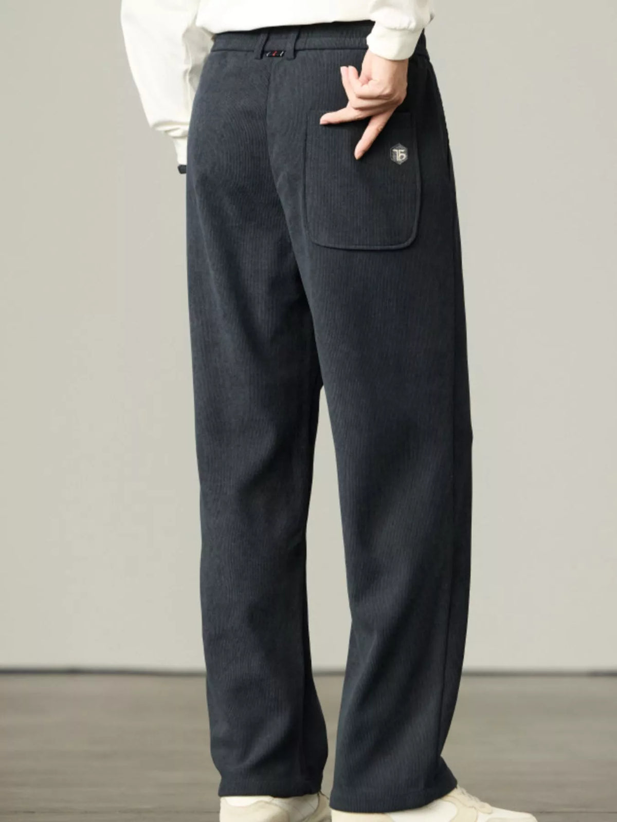 Dark corduroy drawstring relaxed-fit pants with large cargo-style pocket
