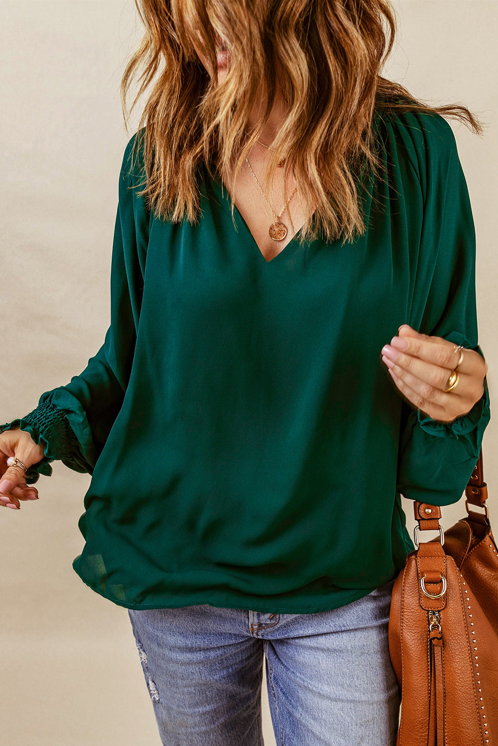 Green V-neck lantern sleeve blouse with elastic ruched cuffs and loose pullover styling