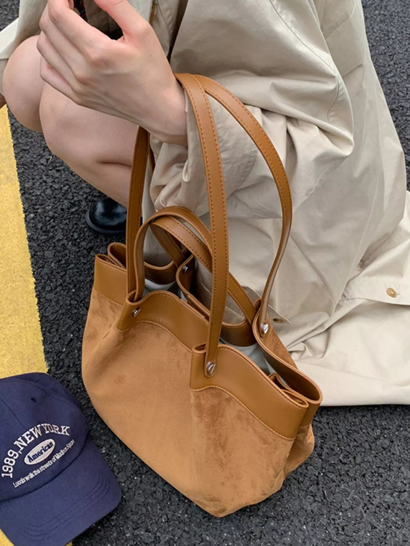 Brown suede shoulder bag with leather handles and top loops