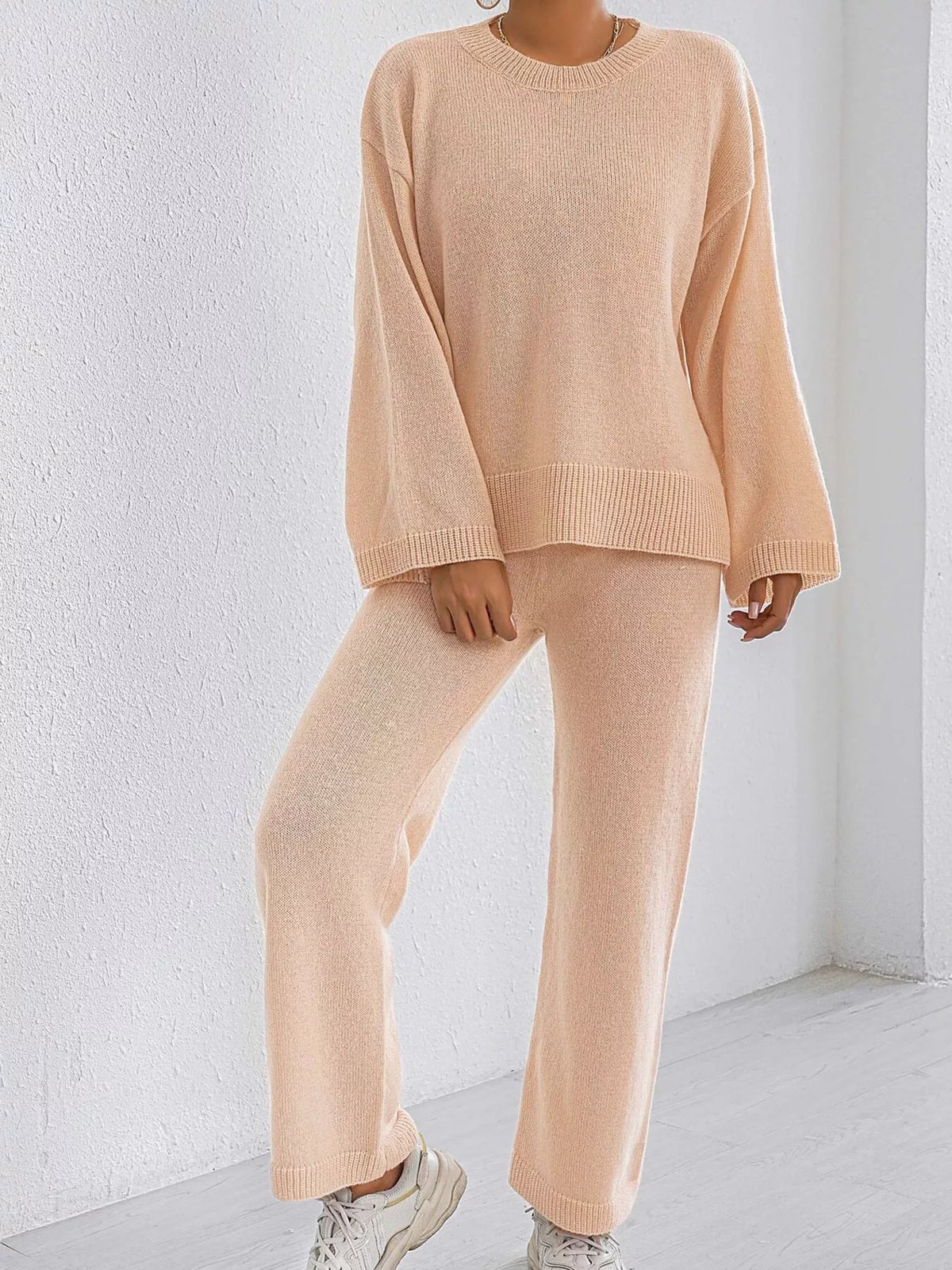 Apricot knit sweater and pants set with dropped sleeves and ribbed cuffs, wide-leg trousers.