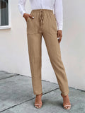 Tan textured drawstring pants with side pockets and ankle-length tapered legs