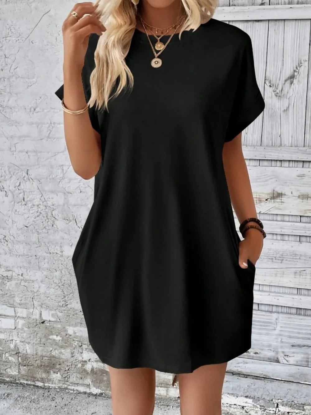 Black pocketed round-neck short-sleeve dress with relaxed fit and side pockets