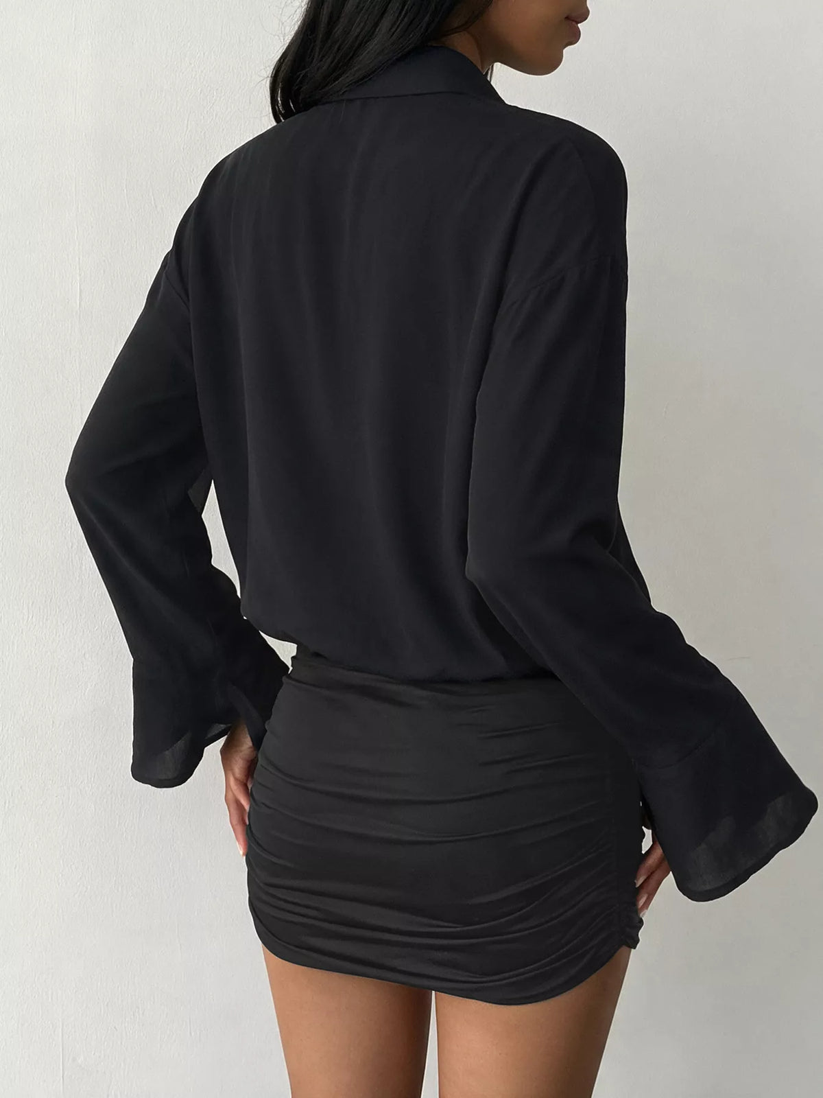 Black button-front shirt dress with ruched mini skirt and flared bell sleeves