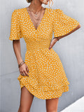 Mustard yellow surplice mini dress with white abstract print, puff short sleeves, smocked waist