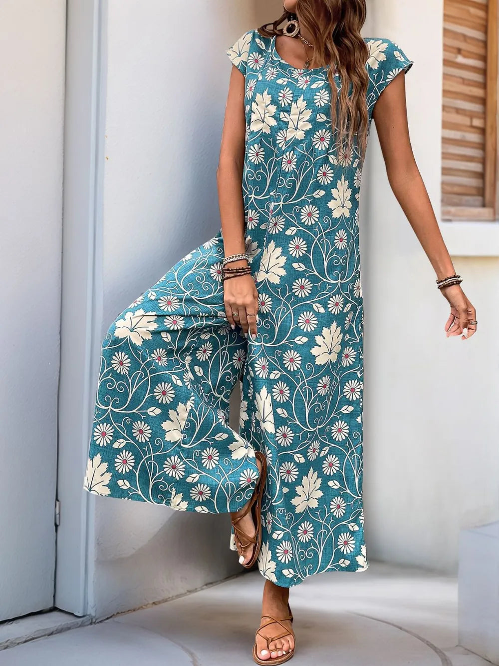 Turquoise floral printed wide-leg jumpsuit with round neck and cap sleeves, ankle-grazing