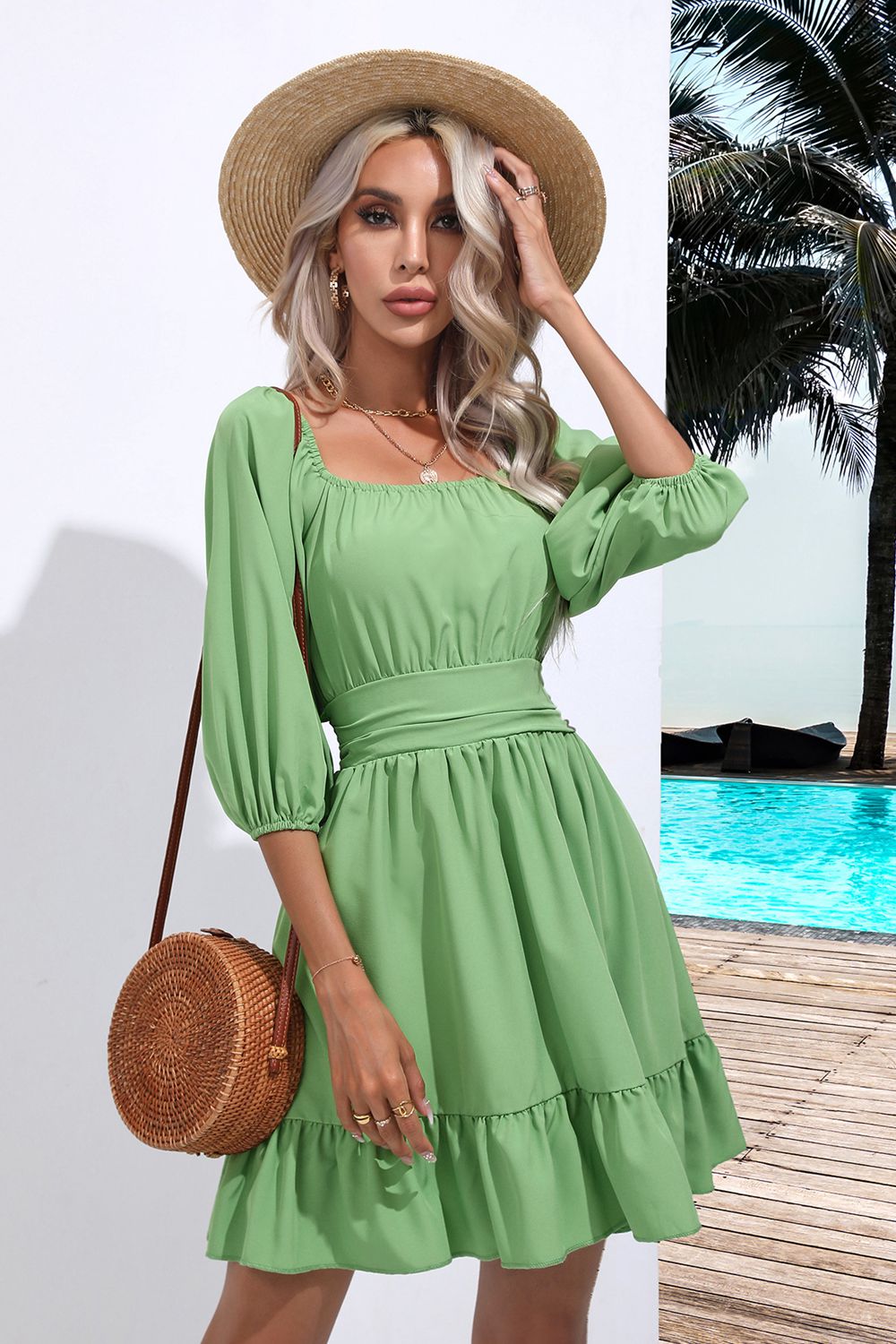 Light green ruffle hem dress with square neckline, gathered waist, and tiered skirt