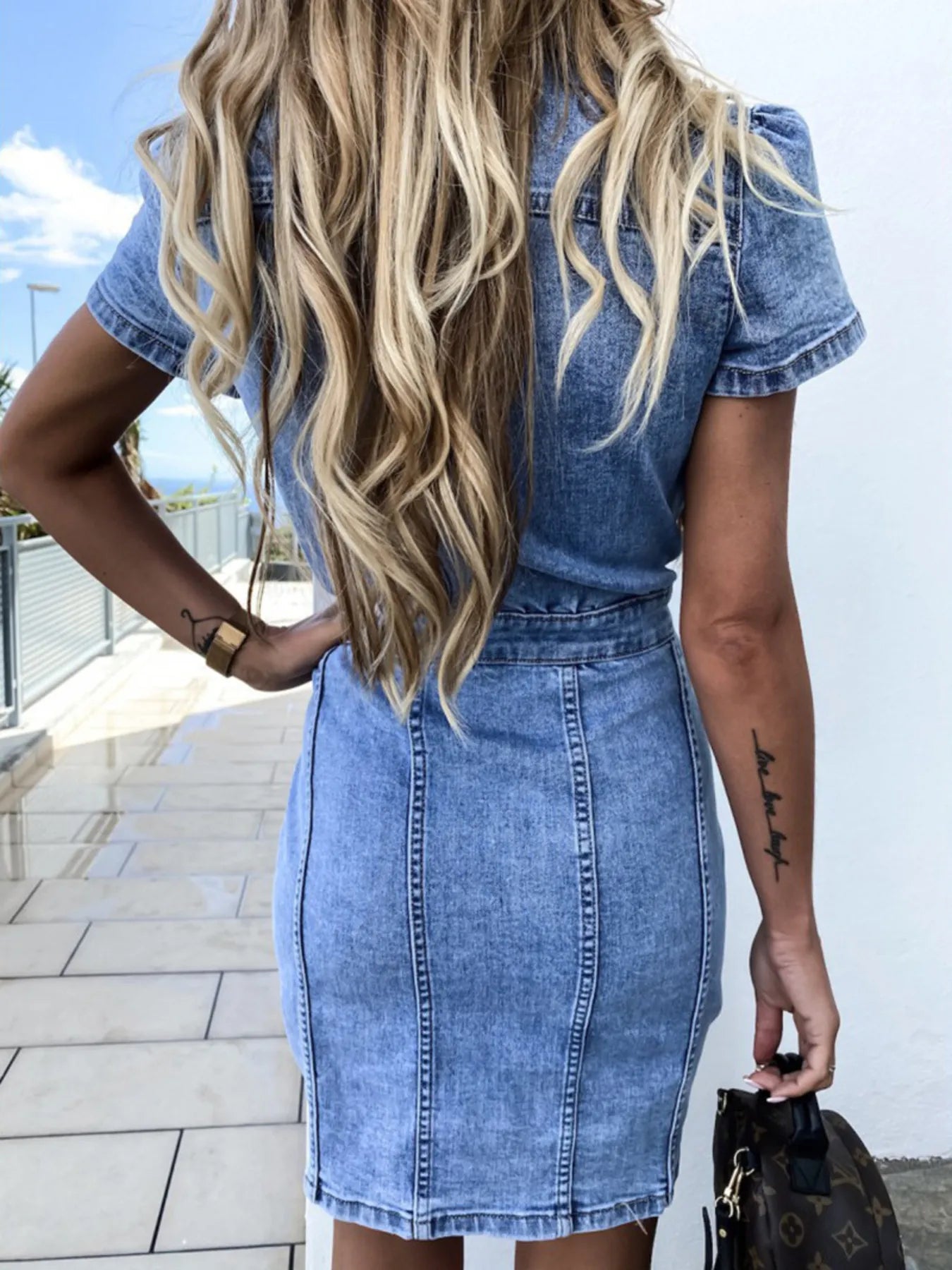 Medium-wash denim short-sleeve dress, viewed from behind
