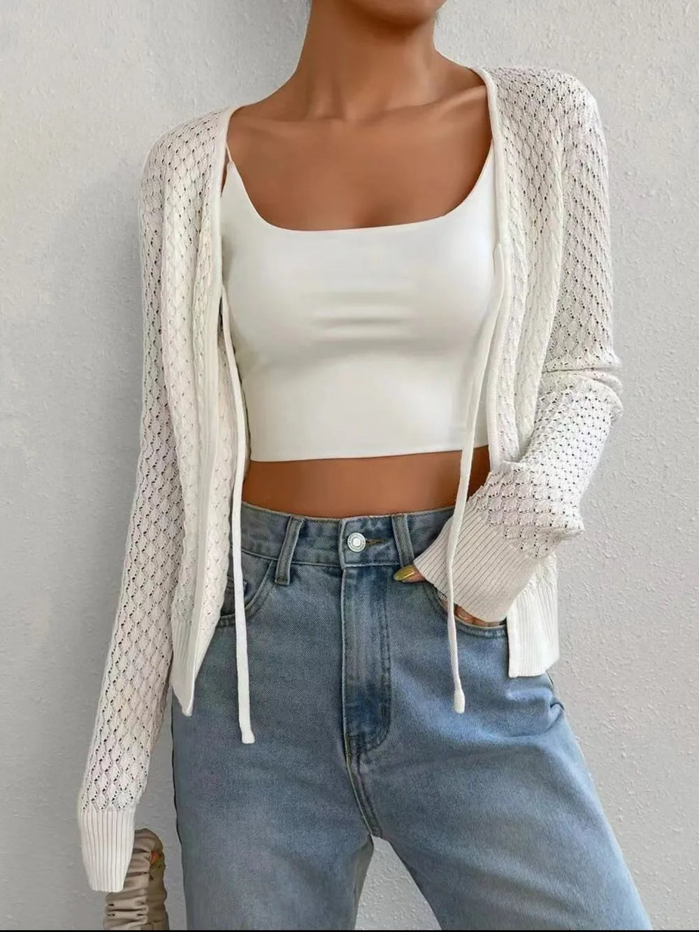 White openwork knit long sleeve cardigan with open front and drawstring ties