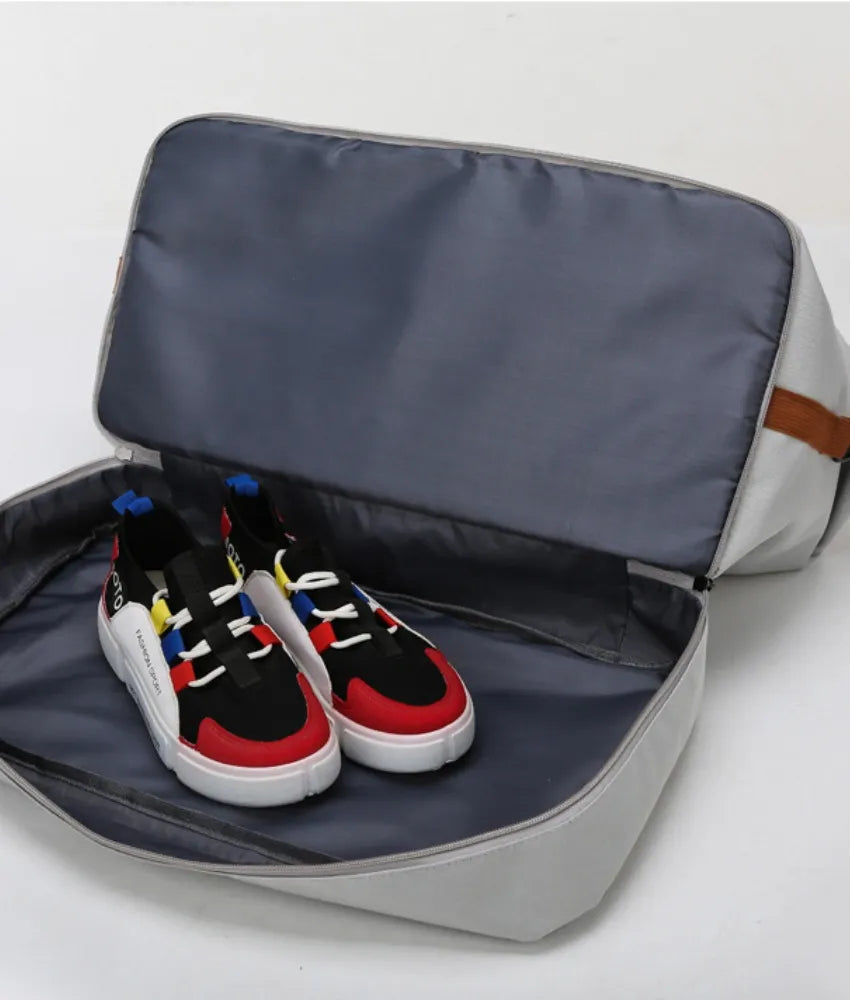 Navy oversize travel duffle bag open showing two pairs of sneakers inside
