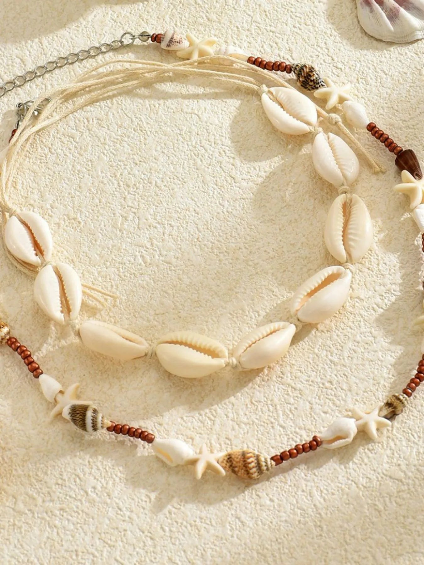 Shell charm necklace set with cowrie shells and starfish, copper bead detail