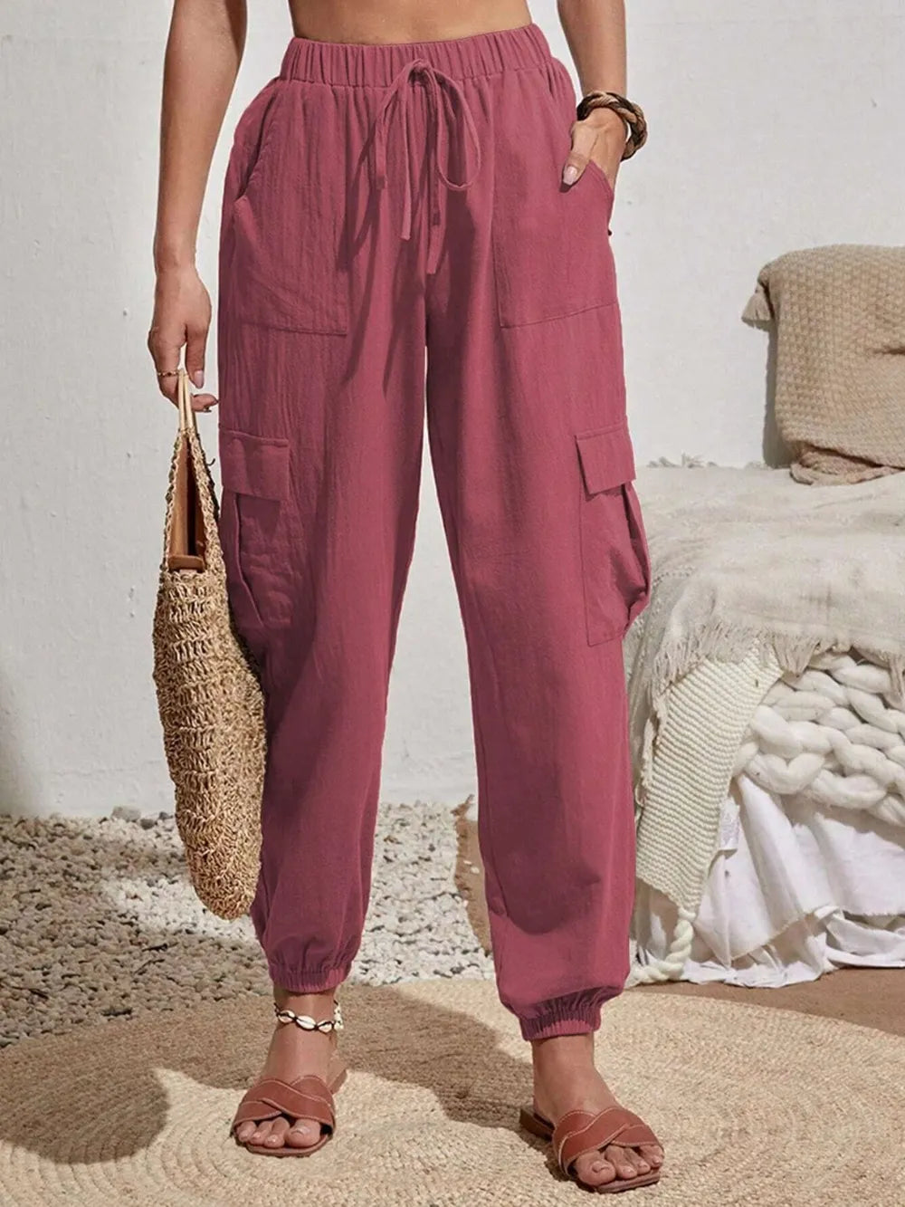 Dusty pink drawstring cargo joggers with side cargo pockets and cuffed ankles