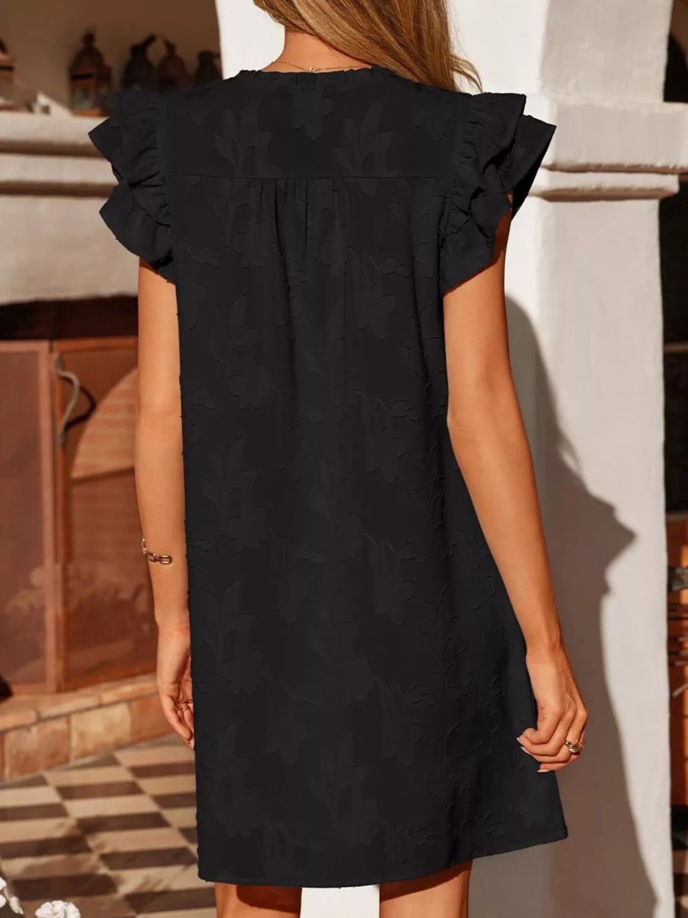 Floral embossed black mini dress with ruffle sleeves, back view Trendsi