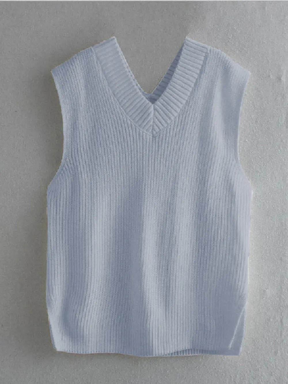 Light blue ribbed V-neck sleeveless sweater vest, solid knit front and back.
