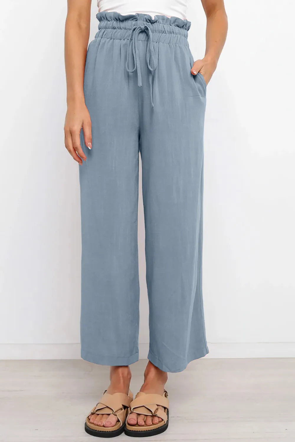 Light blue wide-leg pants with drawstring paperbag-style waist, front view