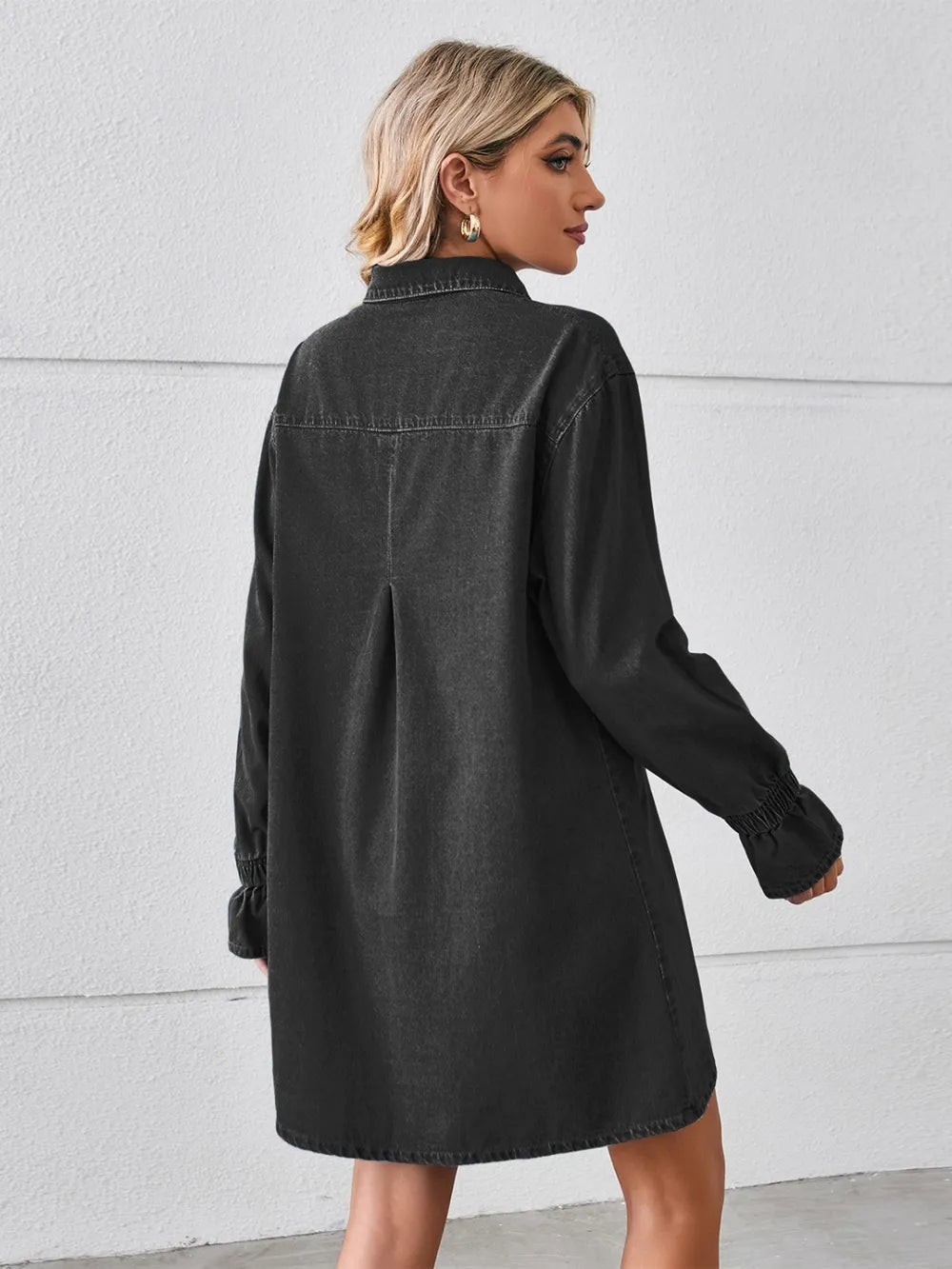 Black denim mini dress, back view, dropped shoulders, button placket, long sleeves