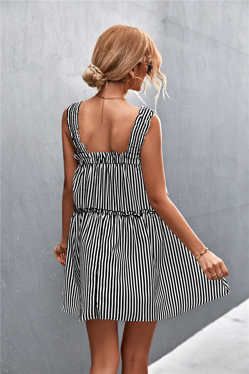 Black and white striped square-neck dress with open back, gathered waist, tiered skirt