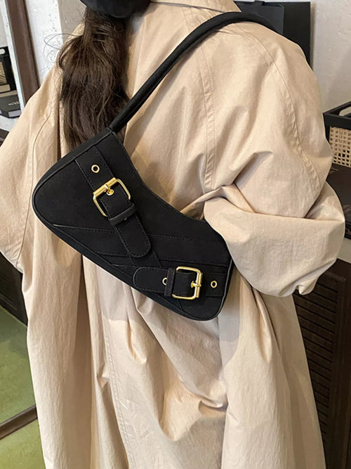 Black buckle decor shoulder bag with gold-tone buckle straps and top zip.