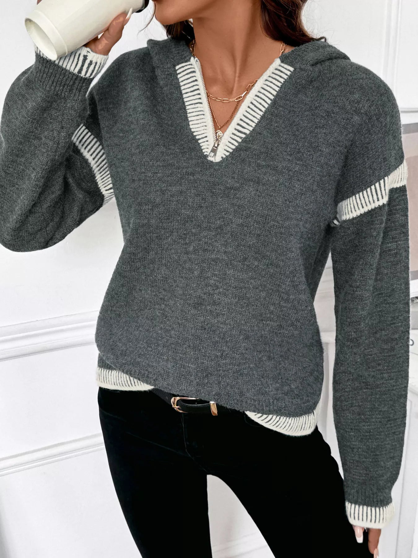 Dark gray hooded quarter-zip sweater with white striped trim and ribbed cuffs