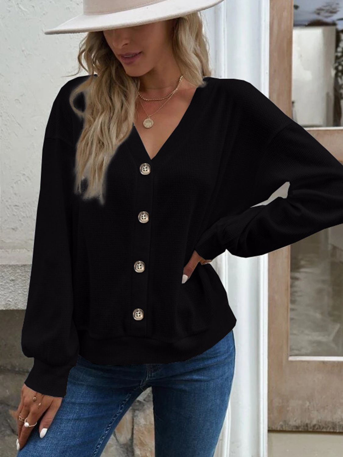 Black V-neck button-front blouse with dropped shoulders and long sleeves
