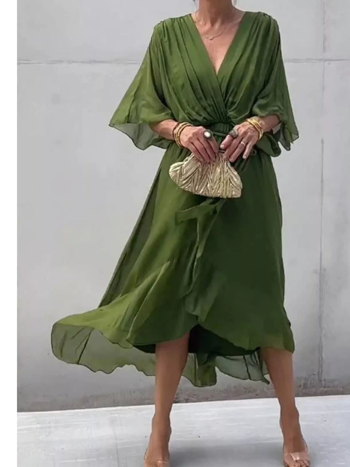 Green ruched wrap dress with batwing sleeves and waist tie, draped midi hem